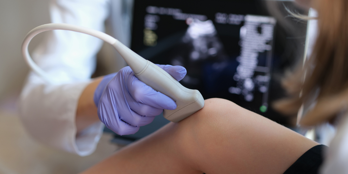 Diagnostic Medical sonographer working on a knee